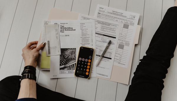 Bill paperwork and calculator on a desk