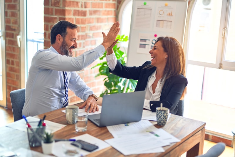 Two business partners celebrating with a high-five